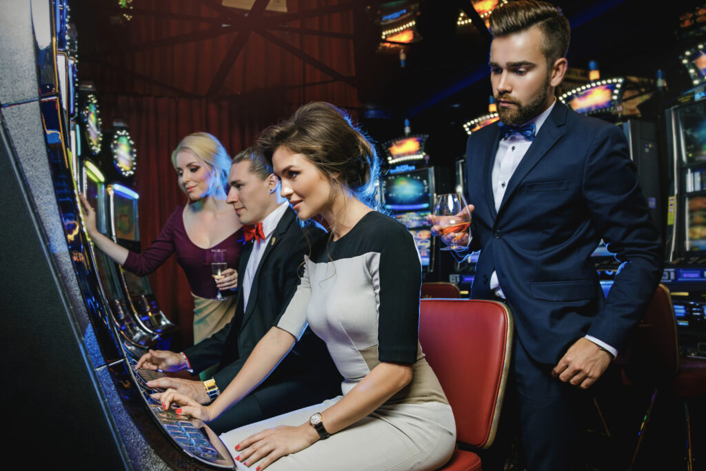 Casino guests playing slot machines, a key target for cybersecurity in gaming environments