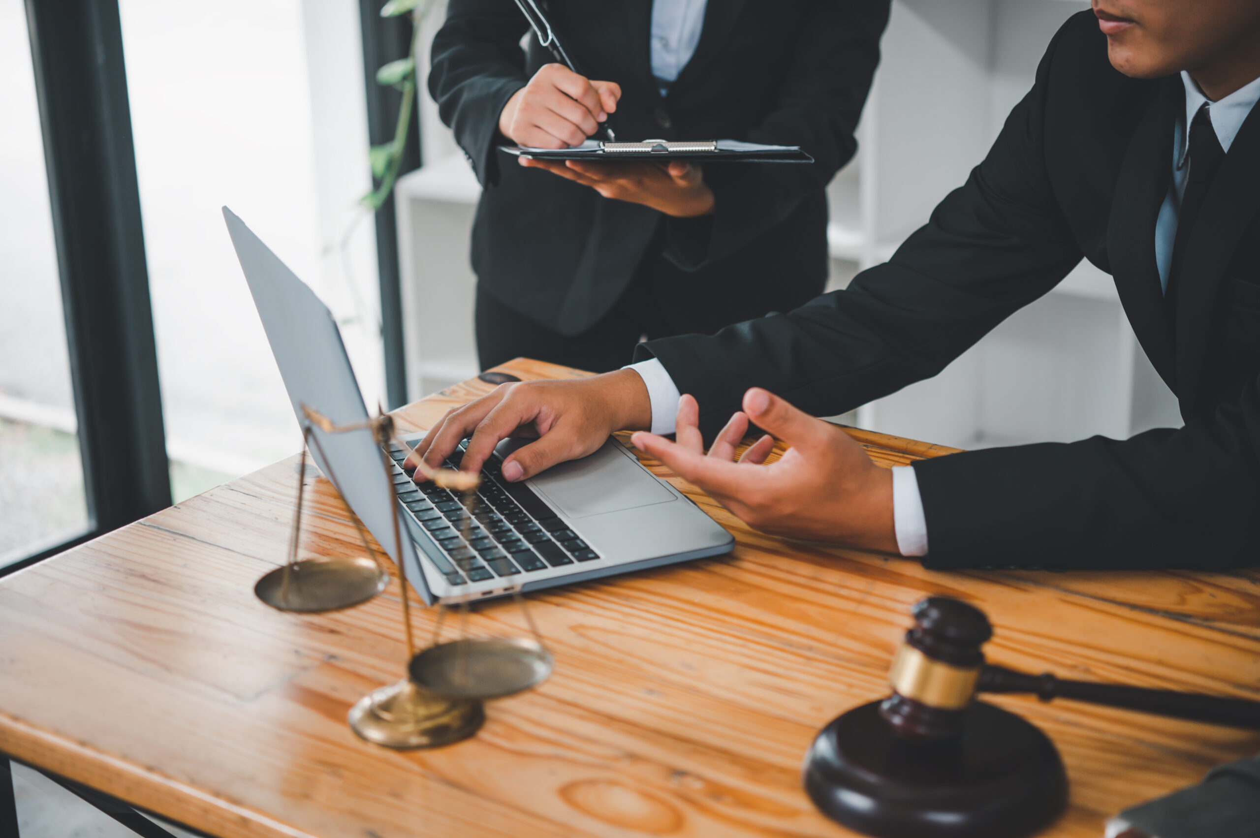 Legal professionals using laptop to discuss cyber security services in law practice
